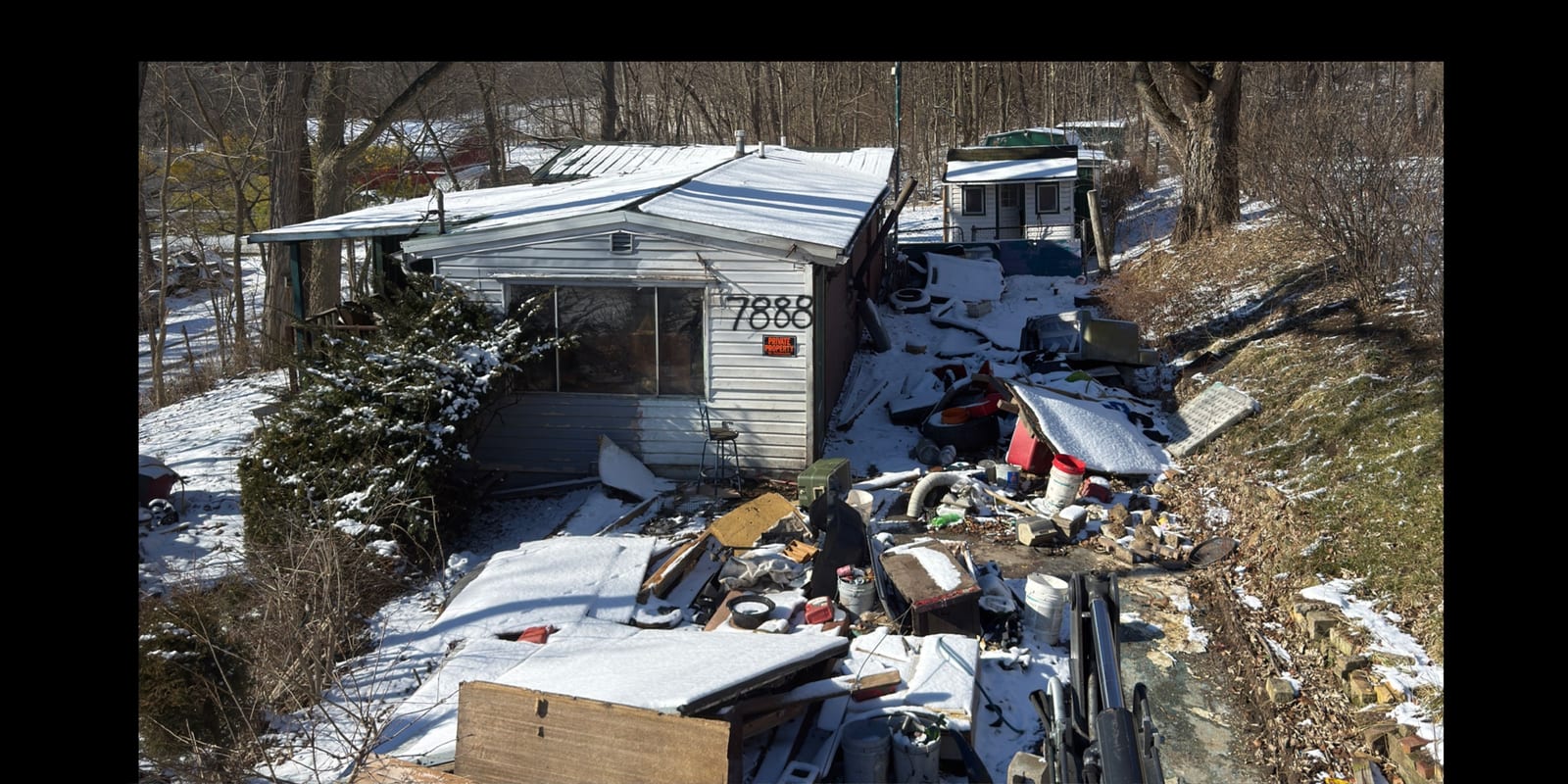 A yard piled with discarded furniture, appliances and household waste